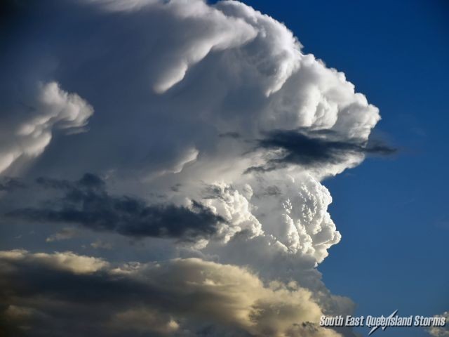 Zoom of the billowing updrafts being lit up by the sunset